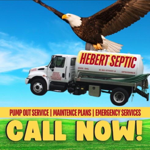 Hebert Septic service truck with a flying eagle in the background.